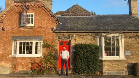 Mark Williamson/BBC Rob Short outside the Queen's Head pub in Newton