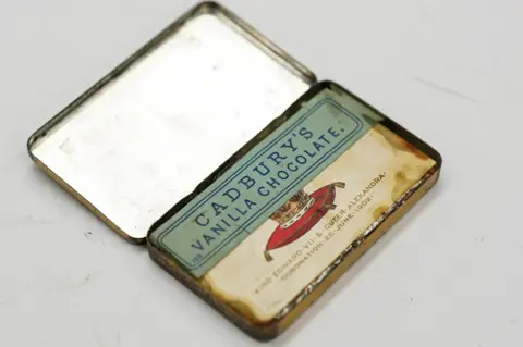 PA Media The tin of the chocolates open