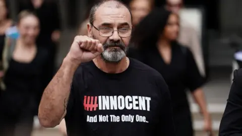 PA Media Andrew Malkinson, who served 17 years in prison for a rape he did not commit, reads a statement outside the Royal Courts of Justice in London, after being cleared by the Court of Appeal.