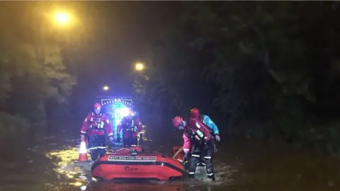 West Midlands Ambulance Service Firefighters in the flood water in Walsall