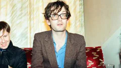 Mirrorpix/Getty Images The band backstage