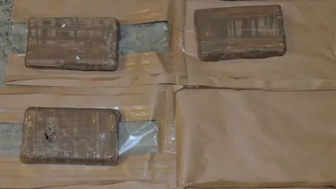 PSNI Class A drugs concealed in brown paper packaging.