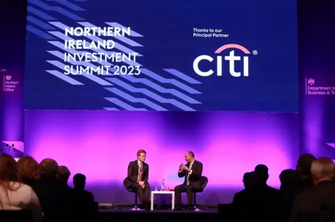 PA Media Two speakers on stage at the Northern Ireland Investment Summit in Belfast