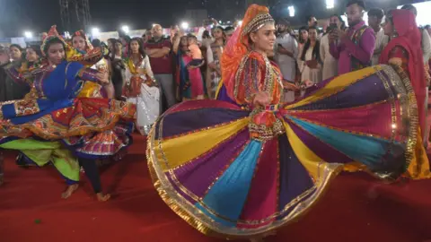 Getty Images People play garba and dandiya during Navratri festival at Falguni Pathak Dandiya 2022 on Tuesday night, at Kandivali, on September 28, 2022 in Mumbai, India.