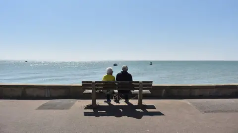 Getty Images Couple looking out to sea