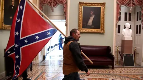 Reuters A protester carries the Confederate flag into the US Capitol building