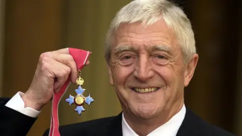 PA Media File photo dated 24/11/2000 of television chat show host Michael Parkinson who was awarded a CBE at Buckingham Palace in London, as he has died at the age of 88.