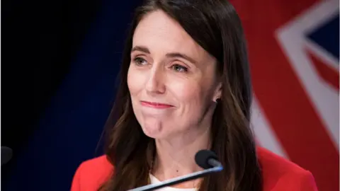 Getty Images Prime Minister Jacinda Ardern speaks at a press conference to announce changes to COVID-19 Omicron vaccine and mandates rules at Parliament on March 23, 2022 in Wellington, New Zealand.