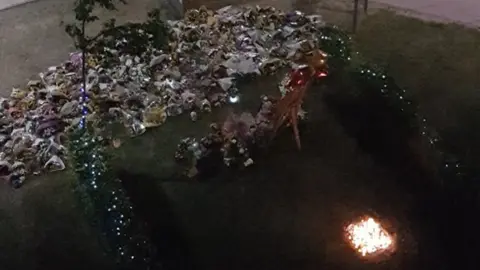 Tracey Harrison/Twitter Candlelit tributes