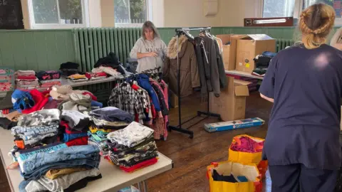 Emma Humphreys Piles of donated clothes