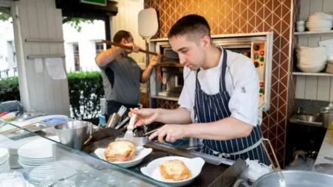 Getty Images Workers in a restaurant