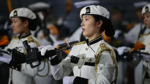 Getty Images A female South Korean solider performs during the 64th anniversary of the Korean war armistice agreement.