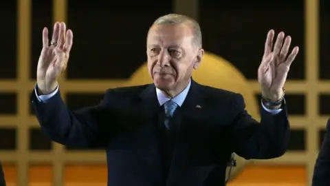 Turkish President Recep Tayyip Erdogan (C) acknowledges supporters after winning re-election in Turkey's run-off vote, at the Presidential Palace in Ankara, Turkey, 28 May