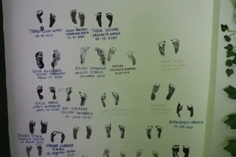 Steven Grattan Footprints on a poster with the names of the babies the parteras have helped give birth