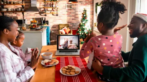 Getty Images Stock photo of a family using zoom at christmas