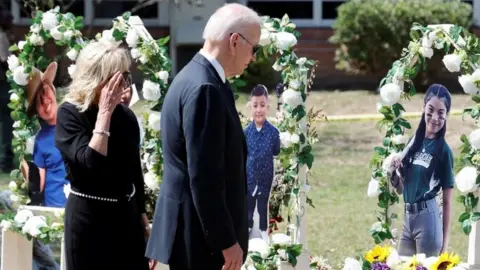 U.S. President Joe Biden and first lady Jill Biden pay their respects at the Robb Elementary School memorial