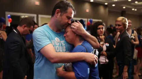 Getty Images Supporters of Jon Ossoff are overcome with emotion during the candidate's concession speech on eleciton night.