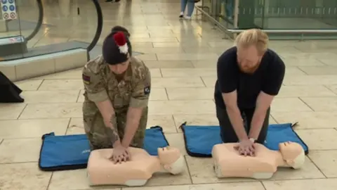 BBC CPR session with dummies on floor