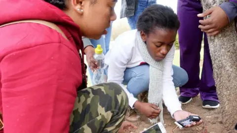 Girls testing a moisture detector