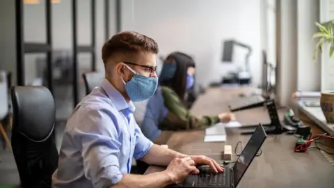 Getty Images office workers wearing masks