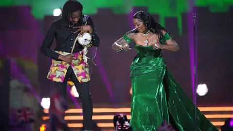 Yui Mok/PA Tiwa Savage (R) and a drummer (L) on stage at the Coronation Concert at Windor Castle, the UK - Sunday 7 May 2023