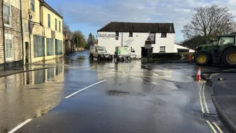 North Yorkshire Council Water covering sinkhole in road in Malton