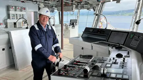 Ferguson Marine boss David Tydeman at the wheel of the Glen Sannox ship