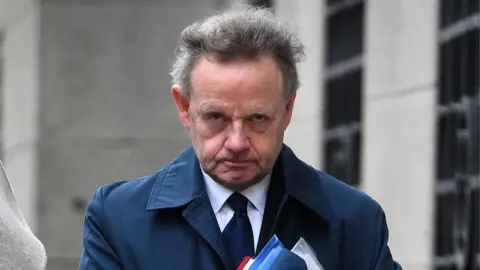PA Andy Hill arriving at court on first day of defence - 13/2/19