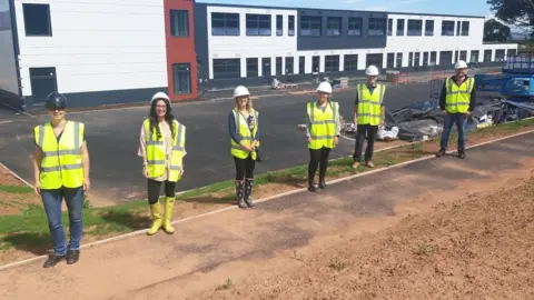 The Castle Partnership Trust Teaching Staff Standing Outside The New Isambard Kingdom Brunel Primary School In Wellington