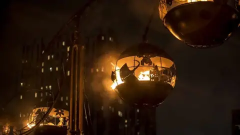 Chris Payne Metal fire-filled orbs in the sky