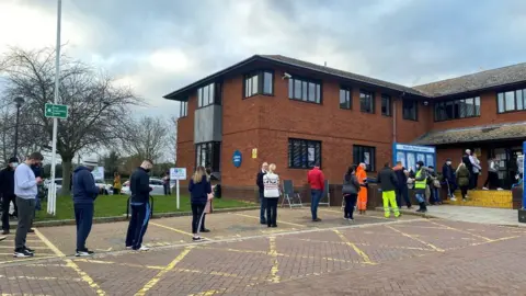 John Fairhall/BBC Queue at vaccination centre