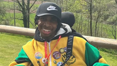 Family handout James smiling in a wheelchair