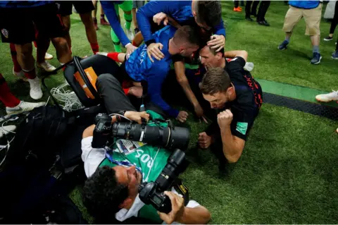 Carl Recine/Reuters Croatia players celebrate next to an AFP photographer Yuri Cortez after Mario Mandzukic scores their second goal