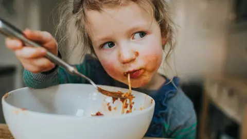Girl eating spaghetti