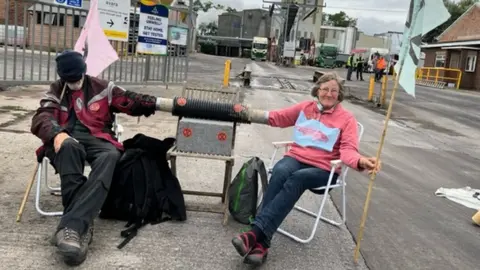 Empics Campaigners sat outside of Sun Valley Poultry