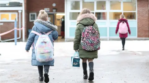 PA Media Pupils arriving at a school and nursery in Cheshire