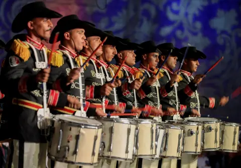 Mohamed Abd El Ghany/Reuters Egyptian drummers in uniform stand in a line and play at a festival in Cairo, Egypt - Saturday 27 May 2023