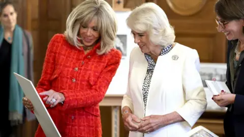 PA Media Brigitte Macron and Queen Camilla at the French National Library ahead of the launch of a