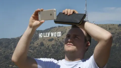 Getty Images A tourist enjoys the view of the Hollywood sign