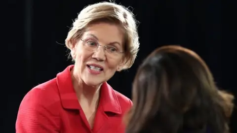 Getty Images Elizabeth Warren speaks to a reporter after the debate in Manchester, New Hampshire. Photo: 7 February 2020