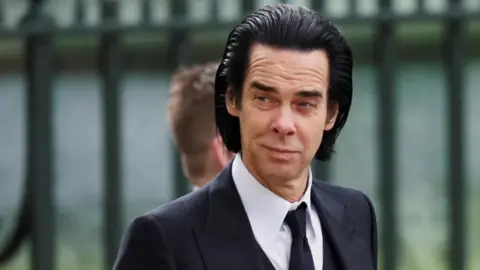 Reuters Nick Cave arriving at Westminster Abbey