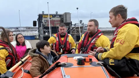 Tommy and his mum meeting RNLI volunteers