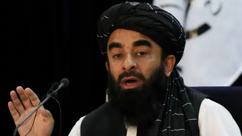 Reuters Taliban spokesman Zabihullah Mujahid announcing the new government