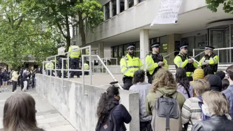 Police outside an Oxford university building, stopping people from entering