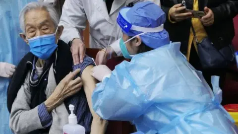 Getty Images Man being jabbed in Beijing