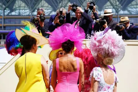 PA Media Racegoers have their picture taken during day three of Royal Ascot at Ascot Racecourse