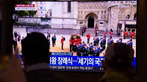 EPA People at a station in Seoul, South Korea, watch a television broadcast of the State Funeral Procession of Queen Elizabeth II.