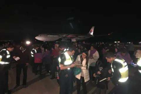 Andrew Leoncelli Passengers were evacuated on to the tarmac after a long wait