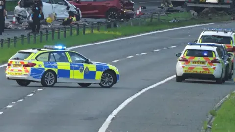 Terry Blackburn Police cars and wreckage on the A1 (M) following the crash