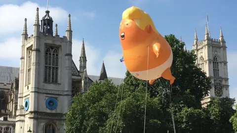 Ben Tavener/ BBC The Trump 'baby blimp' hovers above Parliament Square during a protest over the President's July 2018 visit to the UK